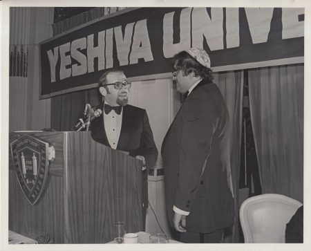 1977.06.00 Yeshiva Award Dinner, Plaza Hotel. Norman Lamm gives a present to Leon Charney on Stage